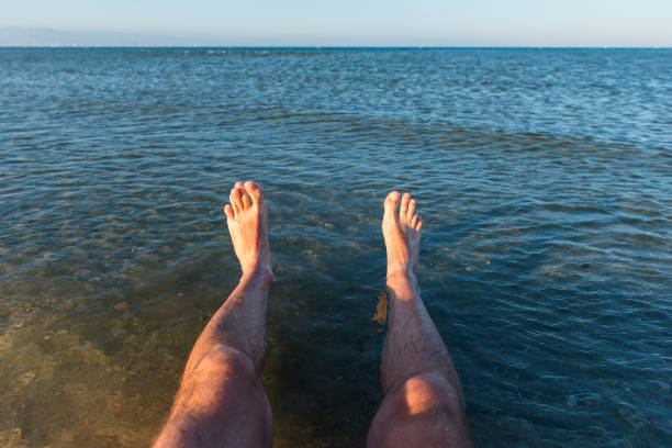 istock Sea waves washing man's feet 958259350
