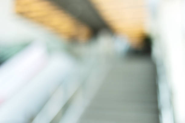 blur image of Close up to escalator yellow and gray steel line. blur image of Close up to escalator yellow and gray steel line. soft focus stock pictures, royalty-free photos & images