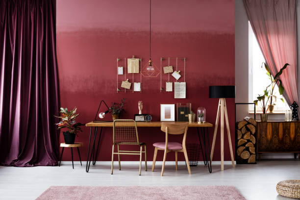 istock Gold and burgundy workspace interior 958260680