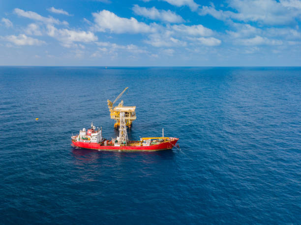 istock Soil Boring Boat (a geotechnical drilling cum analogue survey vessel) close to a oil platform 958271590