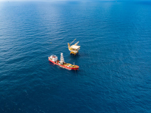 istock Soil Boring Boat (a geotechnical drilling cum analogue survey vessel) close to a oil platform 958271774