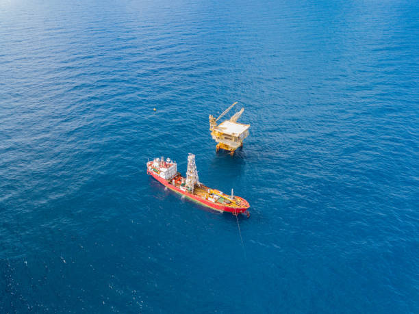 istock Soil Boring Boat (a geotechnical drilling cum analogue survey vessel) close to a oil platform 958272130
