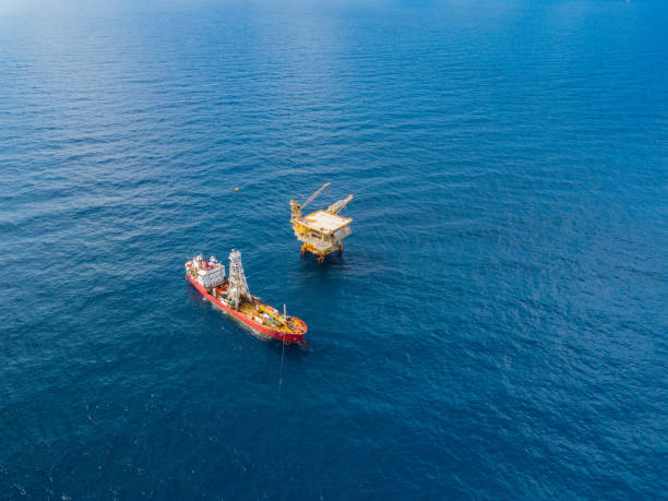 istock Soil Boring Boat (a geotechnical drilling cum analogue survey vessel) close to a oil platform 958272232