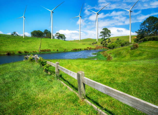 istock Wind turbines farm on a green grass hills. 958279526