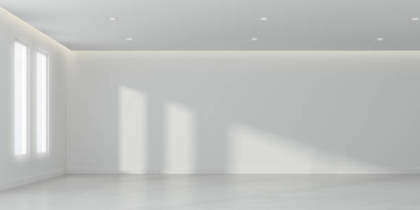 istock 3D rendering of white room space with interior lighting and sun light cast the window shadow on the wall and floor,Perspective of minimal design architecture 958292346