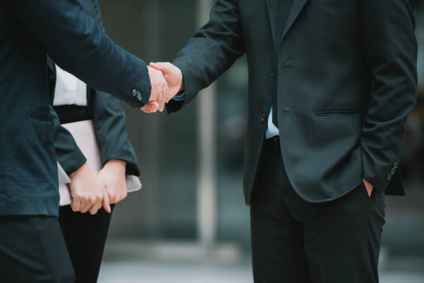 istock business man join hand with business partnership 958292750