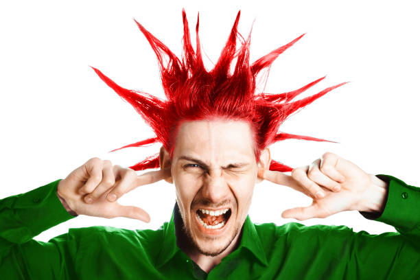 the guy plugged ears A young man with a Mohawk on his head covers his ears mohawk stock pictures, royalty-free photos & images