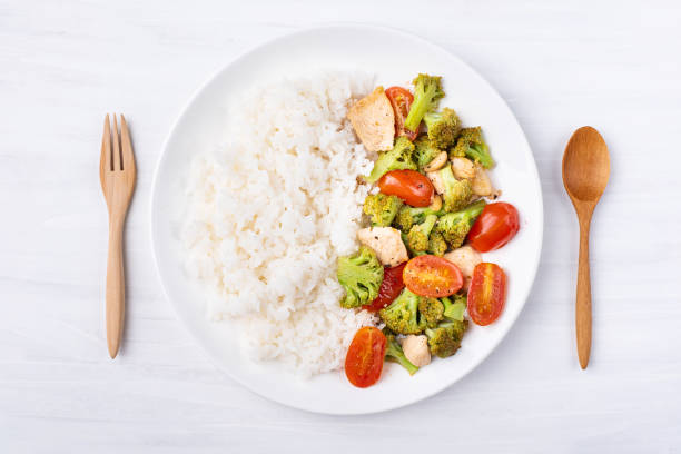 istock Fried broccoli with tomatoes, chicken and cooked rice 958299382