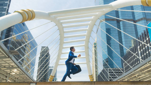istock business man run with laptop briefcase at pedestrian 958304530
