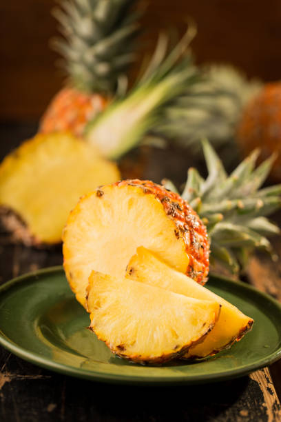 istock Sliced Pineapple on Wooden Background 958304936
