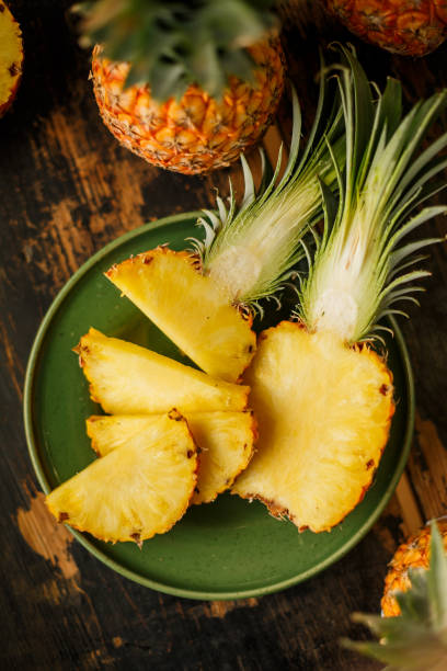 istock Sliced Pineapple on Wooden Background 958304966