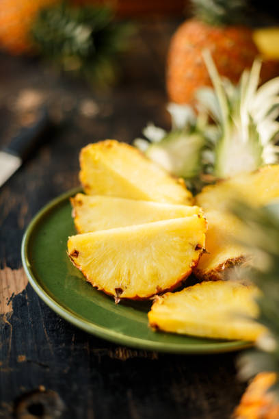 istock Sliced Pineapple on Wooden Background 958304978