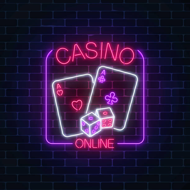 istock Glowing neon sign of online casino application in rectangle frame on dark brick wall background. 958309416
