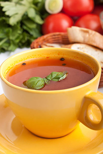 istock tomato soup in yellow cup with ingredients 95831457