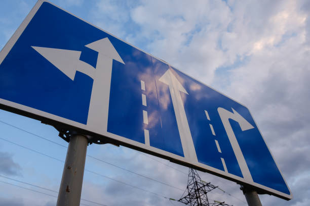 istock directional road signs close-up over blue sky 958320718
