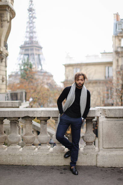 istock Afro american boy standing near concrete railing with Eiffel Tower background in Paris 958331072