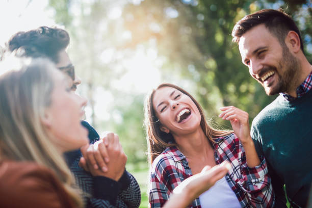 istock Group of young people walking through park 958331784