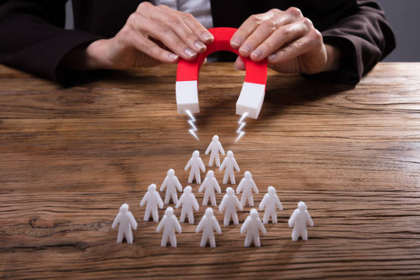 istock Businessperson Attracting Human Figures With Horseshoe Magnet 958332310