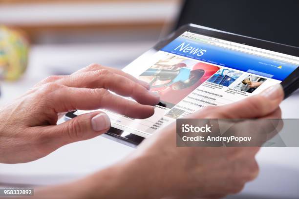 Closeup Of A Persons Hand Using Digital Tablet Stock Photo - Download Image Now - The Media, Newspaper, Internet