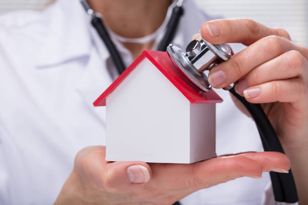 istock Woman Using Stethoscope To Check Model House 958332998