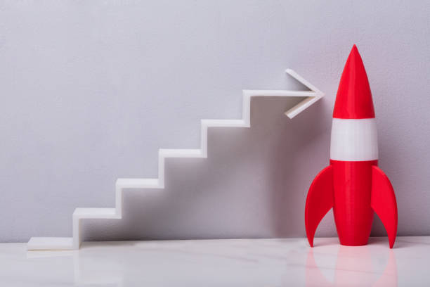 istock Close-up Of Red Rocket Beside White Arrow 958335832