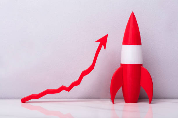 istock Close-up Of Red Rocket Beside White Arrow 958335840