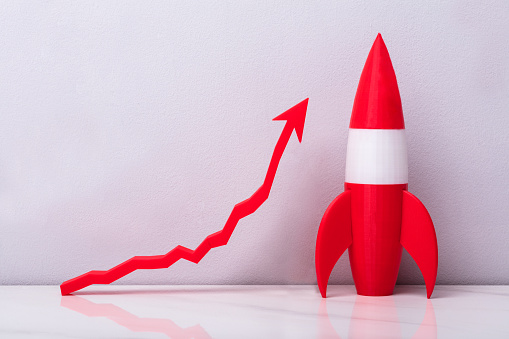 Red Rocket Near White Increasing Arrow Graph On Grey Background