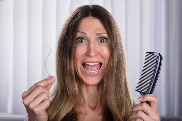 istock Shocked Woman Losing Hair 958335930