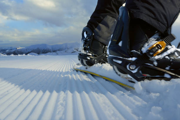 istock Snowboard on  fresh track close-up rear 958336092