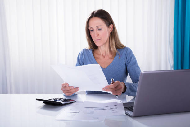 istock Mature Woman Analyzing The Invoice In Office 958336174