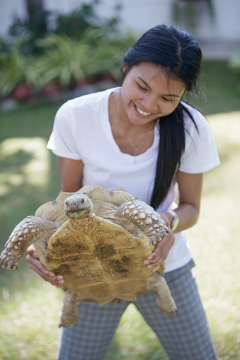 Woman holding tortoise