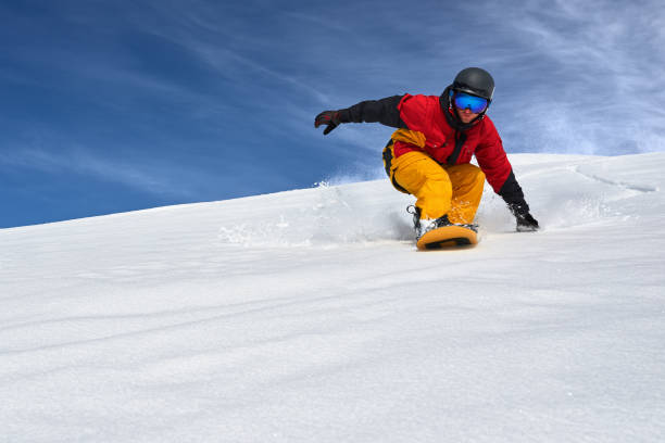 istock snowboarder very quickly goes down slope freerider 958336422