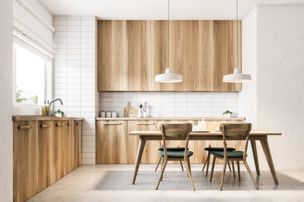 Wooden kitchen and dining room Loft kitchen interior with a concrete floor, light wooden countertops and a wooden table with black chairs. 3d rendering mock up wooden interior stock pictures, royalty-free photos & images