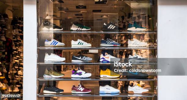 Fashionable Sneakers On Display In Shop Window London Uk Stock Photo - Download Image Now