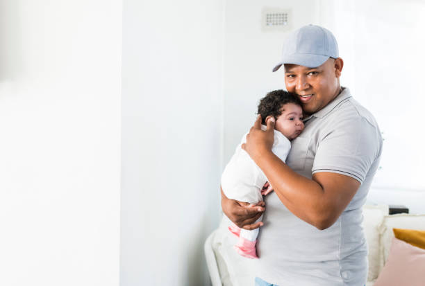istock Proud father holding sleeping baby girl 958353430