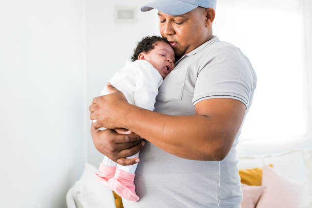 istock Proud father holding sleeping baby girl 958353434
