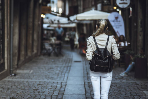 istock Young woman with backpack on the european streets 958359334