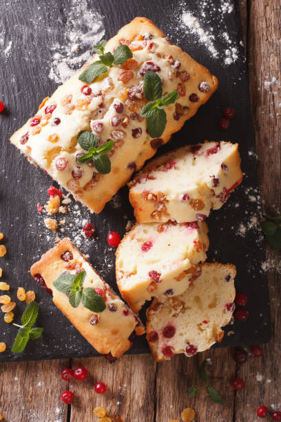 istock sliced fruit cake with cranberries and raisins decorated with mint close up. vertical top view 958359552
