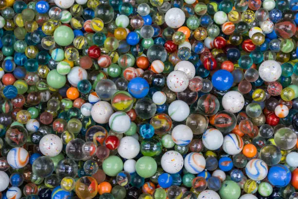 Photo of The background of diversity colorful glass marbles