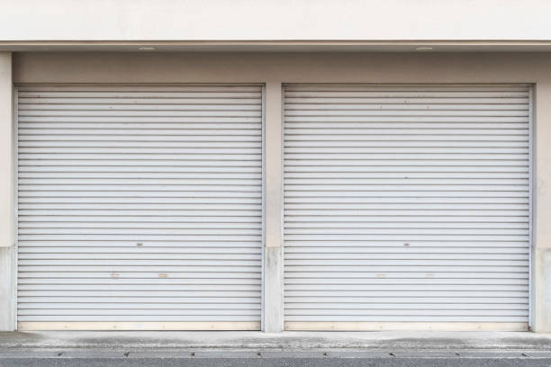 Closed white roller shutter door Closed white roller shutter door shutter door stock pictures, royalty-free photos & images