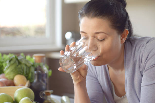 istock woman cooking in the kitchen ( drinking) 958380296