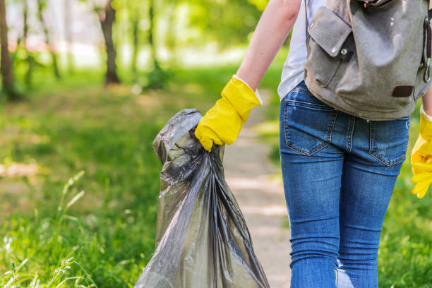 istock Environmental activist collecting plastic garbage in nature 958391658