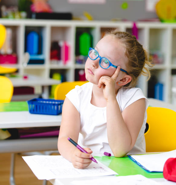istock Beautiful child thoughtful in school 958391954