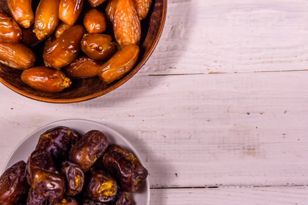 istock Date fruits on the white wooden table. Top view 958392062