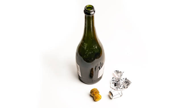Open green bottle with champagne on a white background