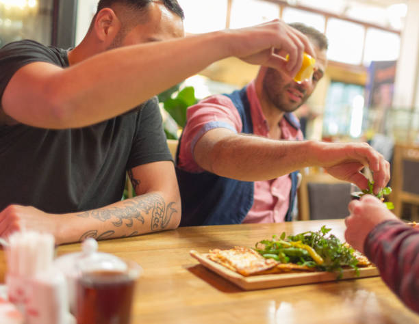 istock People in a restaurant eating Turkish Lahmajoun 958393096