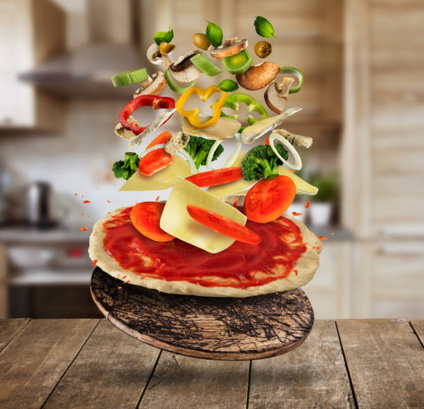 istock Flying pizza ingredients, served on wooden table 958393148