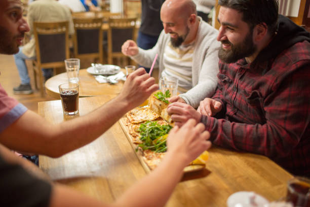 istock People in a restaurant eating Turkish Lahmajoun 958393196