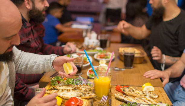 istock Muslim people eating traditional Iftar meal 958393504