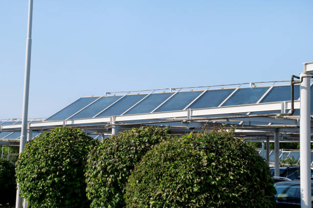 Solar panels. A solar panel and power plant installed on top of a parking lot. Photovoltaic panels for renewable electric energy production. Solar cells electricity farm. Summer, sunlight, sun's rays. paneles solares. un panel solar y planta instalada sobre una porción del estacionamiento. paneles fotovoltaicos para producción de energía eléctrica renovable. granja de electricidad de las células solares. verano, la luz del sol, los rayos del sol.